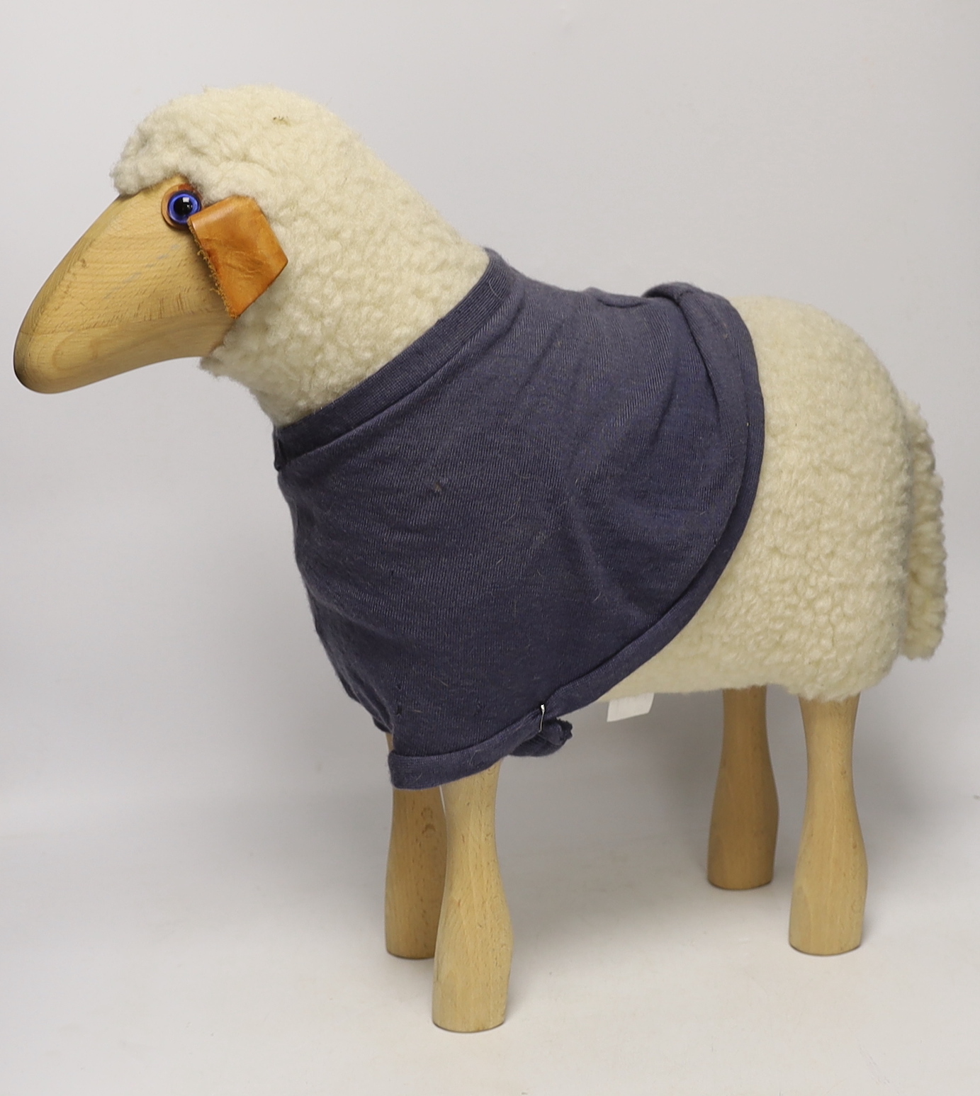 A Hanns-Peter Krafft sheep for Mayr Wool, beech body with wool and leather details, 46cm high